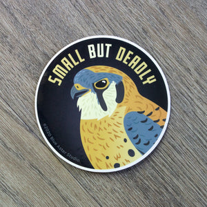 A round vinyl sticker with an illustration of an American Kestrel and the words "Small But Deadly"