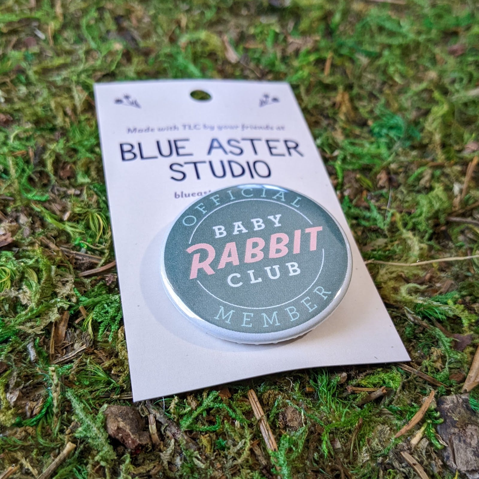 A close up of the Baby Rabbit Club button.