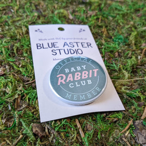 A close up of the Baby Rabbit Club button.