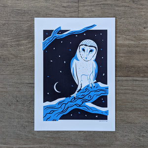 An art print of a barn owl perched on a snowy tree branch with a moon and stars in the background