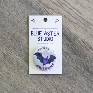 A 1.5" button with an illustration of a bat flying in front of a full moon with the words "Bat's So Awesome"