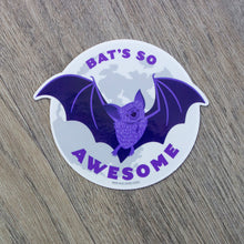 Load image into Gallery viewer, A vinyl sticker with a cute bat flying in front of the moon and the words Bat’s So Awesome.