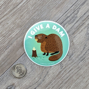 A beaver sticker sitting next to a USD quarter to show scale.