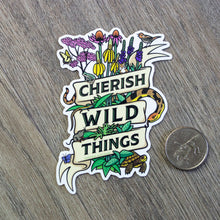 Load image into Gallery viewer, The Cherish Wild Things vinyl sticker with illustrations of prairie plants and animals next to a USD quarter for scale