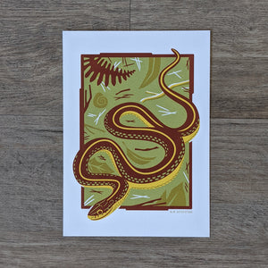 An art print of a garter snake slithering through some leaf litter and twigs.
