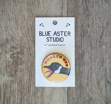 Load image into Gallery viewer, A 1.5 inch pinback button featuring an illustration of a goose with its beak open wide and the words &quot;Honked Off&quot; above it.
