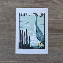 Load image into Gallery viewer, An art print of a great blue heron standing in a wetland.