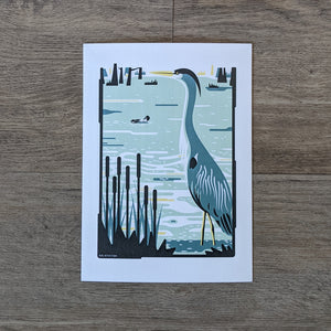 An art print of a great blue heron standing in a wetland.