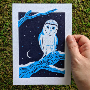 A hand holding a 5x7 inch art print of a barn owl.