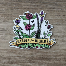 Load image into Gallery viewer, A vinyl sticker with illustrations of native midwestern US plants such as wild ginger, common milkweed, liatris, bee balm, and echinacea with critters all around them including birds, butterflies, and other insects. At the bottome of the sticker there is a banner that reads &quot;Garden For Wildlife&quot;