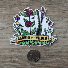 Load image into Gallery viewer, The Garden For Wildlife vinyl sticker sitting next to a USD quarter to show scale.