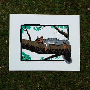 A screen print of a squirrel lounging on a tree branch.