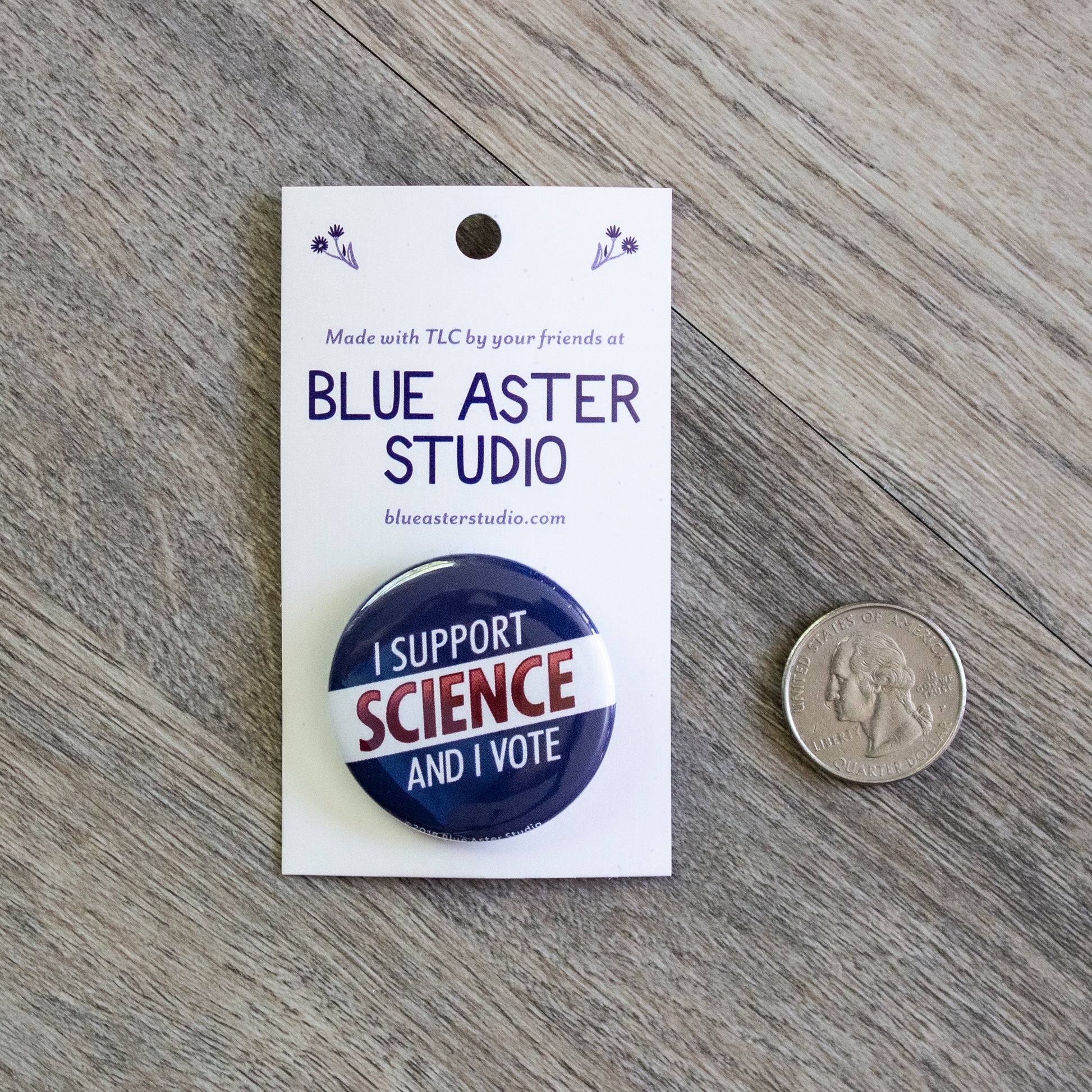 The I Support Science button next to a USD quarter for scale.