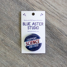 Load image into Gallery viewer, A 1.5 inch red, white, and blue pinback button with the words I Support Science And I Vote.