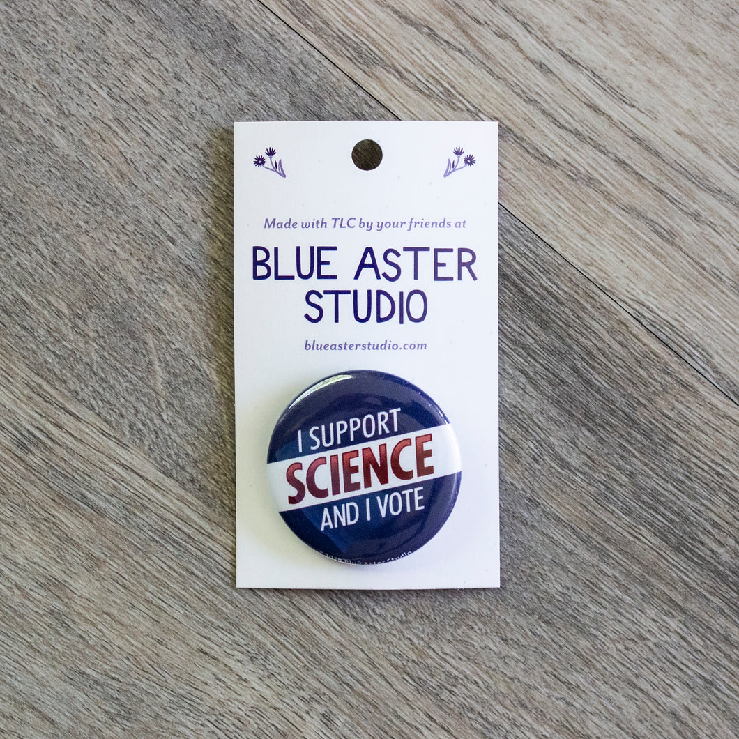 A 1.5 inch red, white, and blue pinback button with the words I Support Science And I Vote.