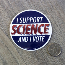Load image into Gallery viewer, A round vinyl sticker with the words I Support Science And I Vote next to a USD quarter for scale.