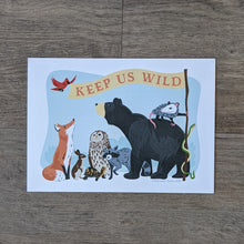 Load image into Gallery viewer, An art print of an illustration of a group of animals (bear, opossum, snake, raccoon, owl, turtle, rabbit, fox, and bird) holding a flag that reads &quot;Keep Us Wild&quot;