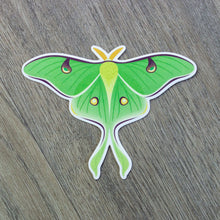 Load image into Gallery viewer, A vinyl sticker of a luna moth.