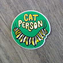 Load image into Gallery viewer, A round vinyl sticker with an illustration of a monarch caterpillar and the words Cat Person above it.
