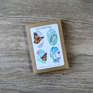 A monarch stationery set including four designs featuring monarch butterflies, a monarch caterpillar, and a monarch chrysalis. The monarch card set includes eight total cards with envelopes and is packaged in a kraft paper box.
