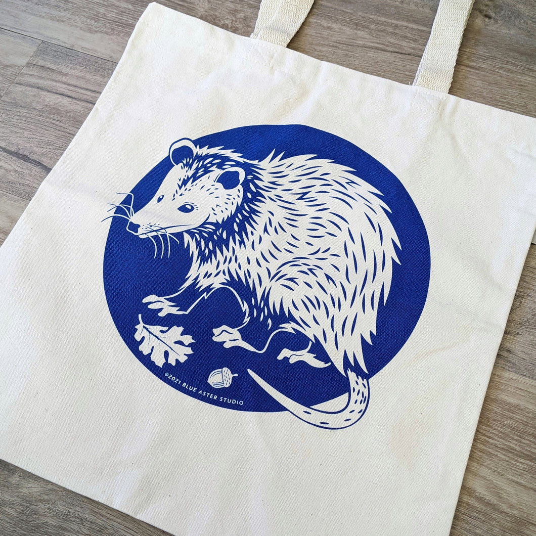 Close up picture of the screen printed opossum design on the tote bag.