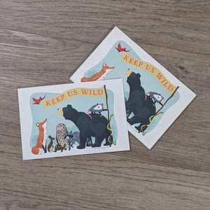 A stack of "Keep Us Wild" postcards with one set off to the side.