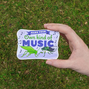 Hand holding the singing insect vinyl sticker