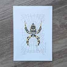 Load image into Gallery viewer, An original screen print of an orbweaver spider on a web. Printed in three colors of silver, yellow and black.