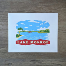 Load image into Gallery viewer, A scene on Lake Monroe that shows a pontoon boat and some swimmers surrouned by the treen lined shore of the Southern Indiana lake. At the bottom is a banner that reads &quot;Lake Monroe.&quot; The screen print is inspired by vintage postcard art.
