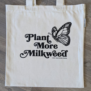 A monarch butterfly tote bag with the words "Plant More Milkweed" and a monarch butterfly printed on it.