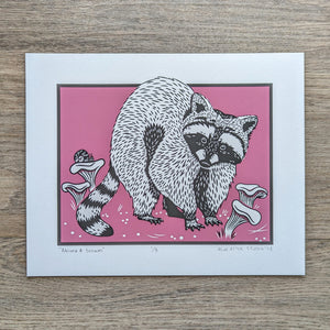 An illustration of a raccoon in a patch of chanterelle mushrooms with a pink background. This is an original Blue Aster Studio screen print that is signed and numbered.