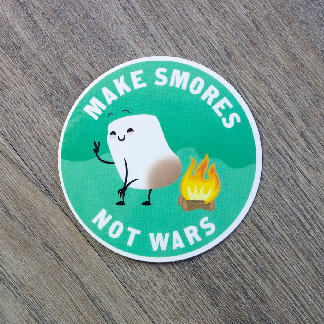 A round vinyl sticker with an illustration of a cute marshmallow toasting its butt on a campfire with the words Make S’Mores Not Wars.