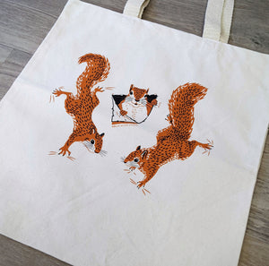 A close up of the squirrel illustrations that are screen printed on the durable organic cotton tote bag.