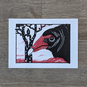 An art print of a turkey vulture face in profile in the foreground. There is a dead tree with another turkey vulture perched in it in the background.