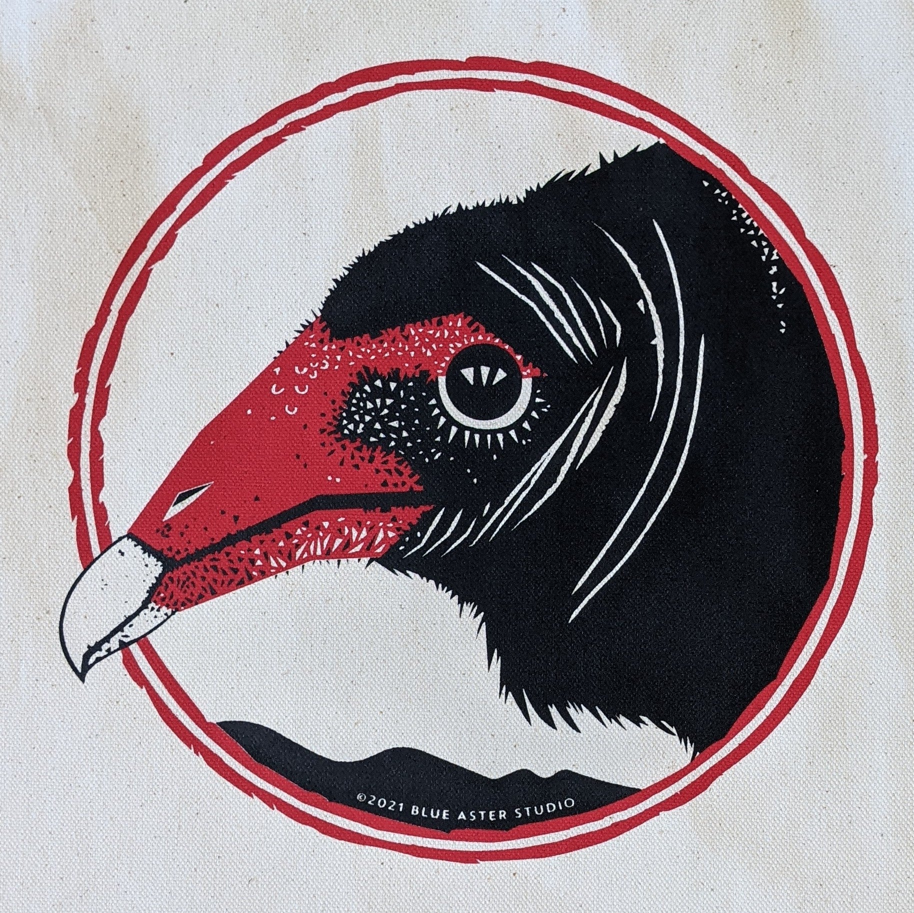 A close-up of the turkey vulture screen printed design on the tote bag.