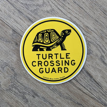 Load image into Gallery viewer, A 3 inch round vinyl sticker with the words &quot;Turtle Crossing Guard&quot; and an illustration of a box turtle in black on a yellow background.