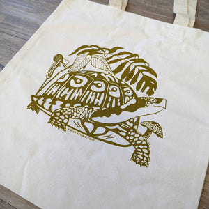 A close up of the screen printed turtle design on the durable organic cotton tote bag. This turtle tote bag features a turtle surrounded by native woodland plants.