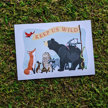 Load image into Gallery viewer, An art print of an illustration of a group of animals (bear, opossum, snake, raccoon, owl, turtle, rabbit, fox, and bird) holding a flag that reads &quot;Keep Us Wild&quot;