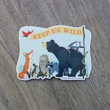 Load image into Gallery viewer, A vinyl sticker with an illustration of a fox, rabbit, turtle, owl, raccoon, bear, opossum, snake, and bird holding a flag that reads &quot;Keep Us Wild&quot;