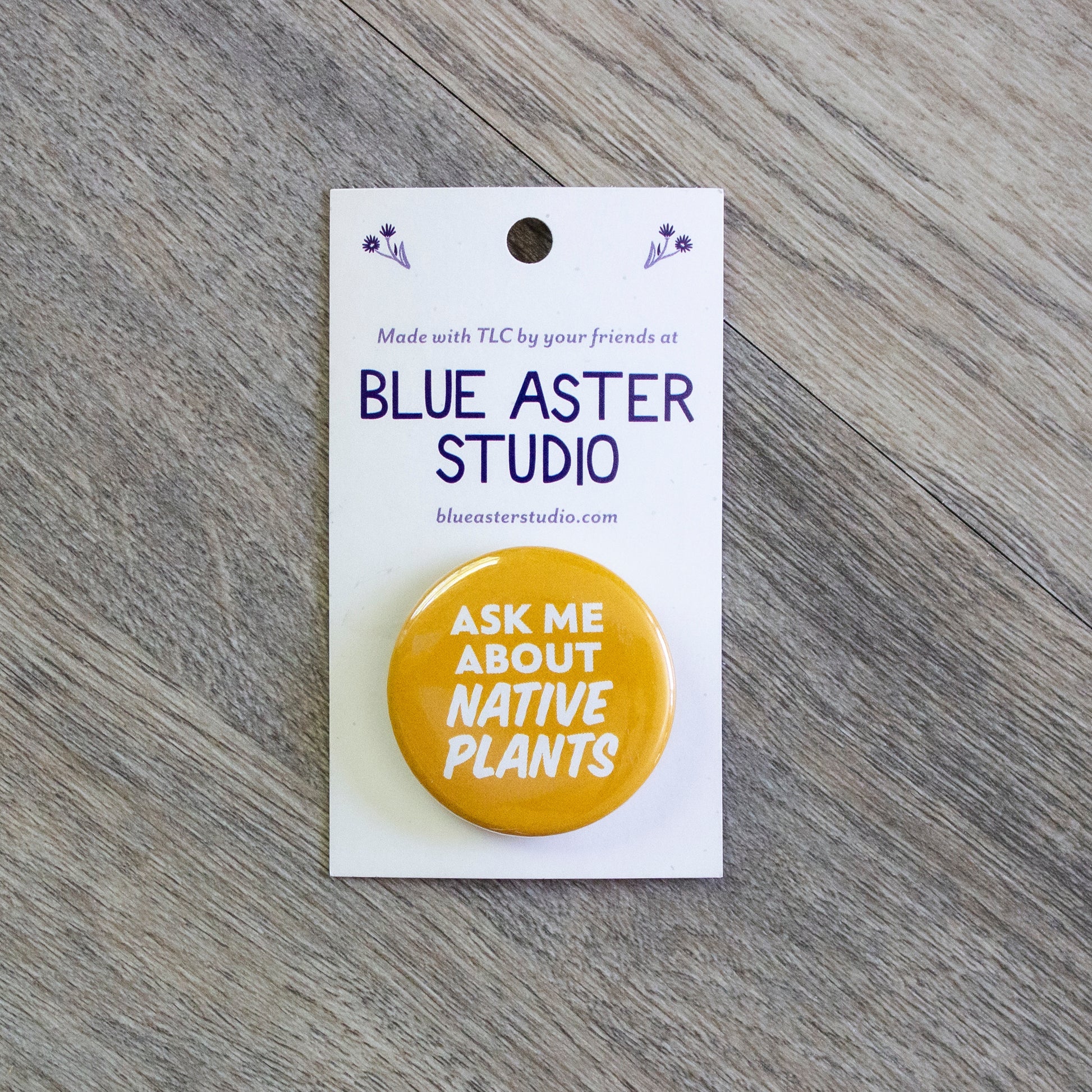 A 1.5 inch yellow pinback button with the words Ask Me About Native Plants in white