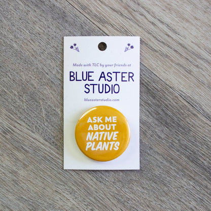 A 1.5 inch yellow pinback button with the words Ask Me About Native Plants in white