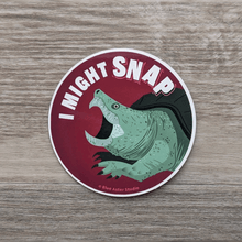 Load image into Gallery viewer, A round vinyl sticker featuring an illustration of a snapping turtle an the words &quot;I Might Snap&quot; 