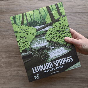 A hand holding the Leonard Springs Nature Park art print to show scale.