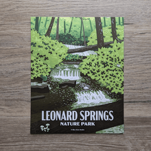 Load image into Gallery viewer, An art print featuring an illustration of the falls at Leonard Springs Nature Park. The falls in the illustration are surrounded by spring greenery with a few fallen trees across the water. There are some songbirds hidden in the shrubs around the water as well.